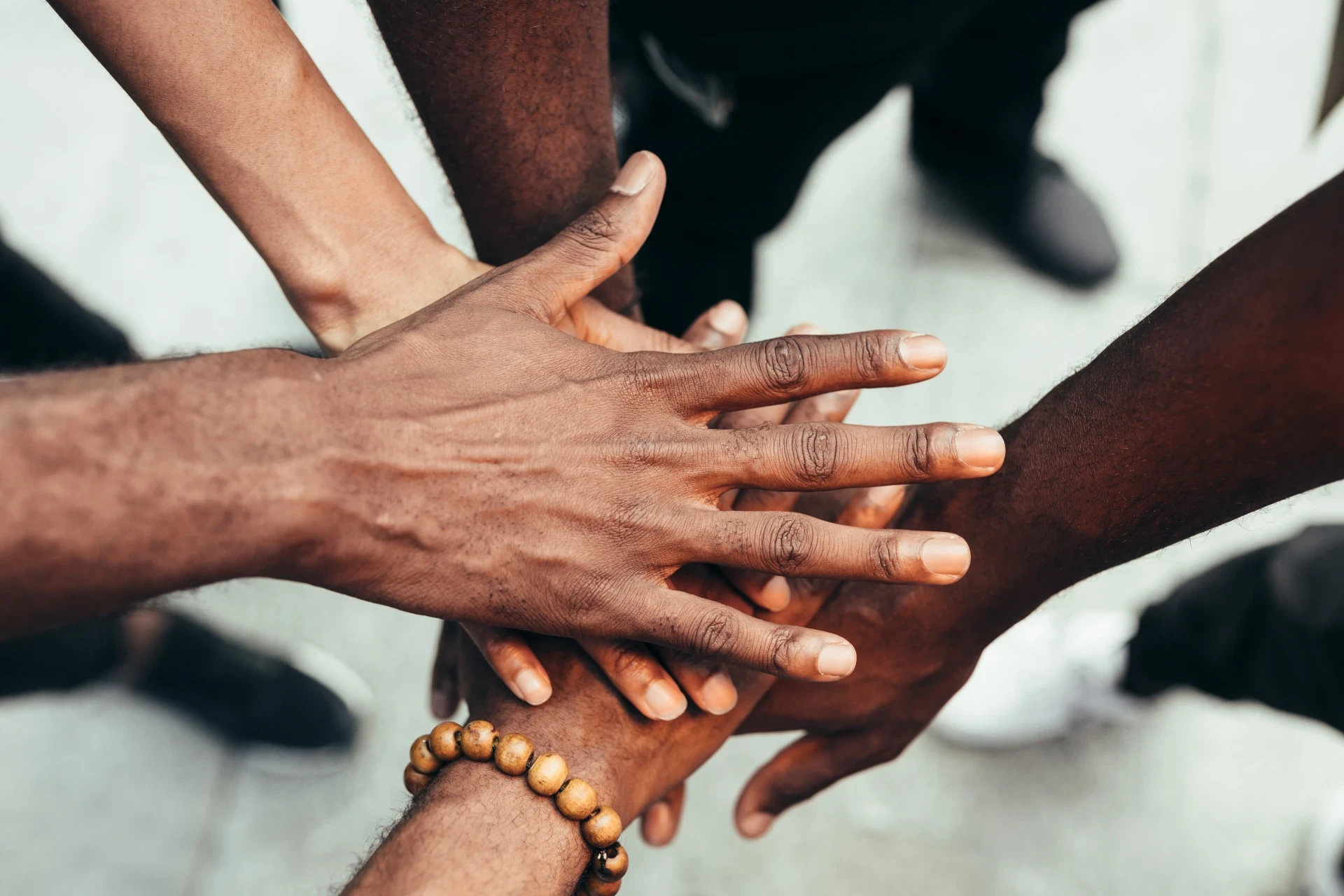 Stacked hands of a diverse team showing trust and collaboration
